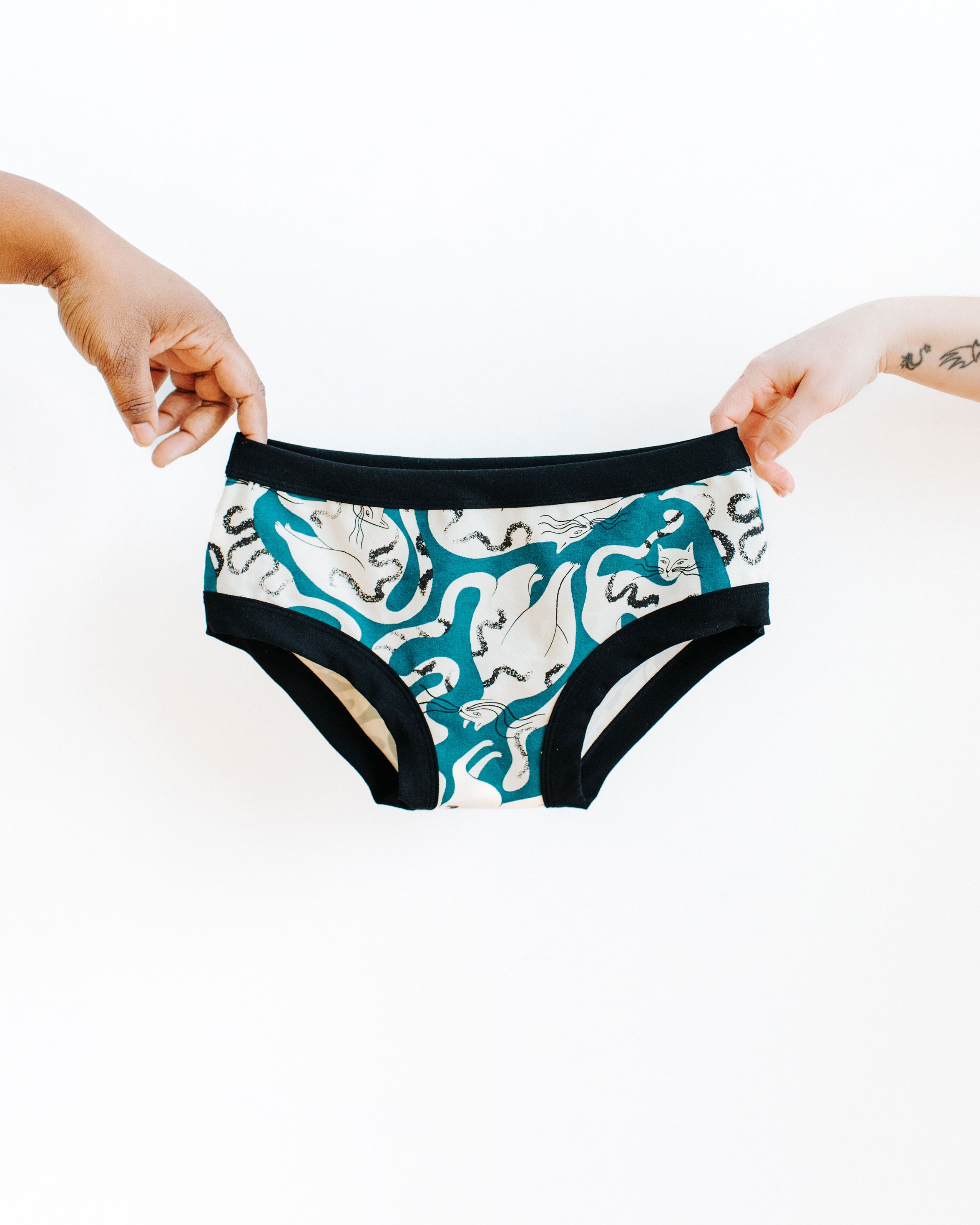 Thunderpants Hipster style underwear being held up by two hands in Hey Meow! print - green and white cats.