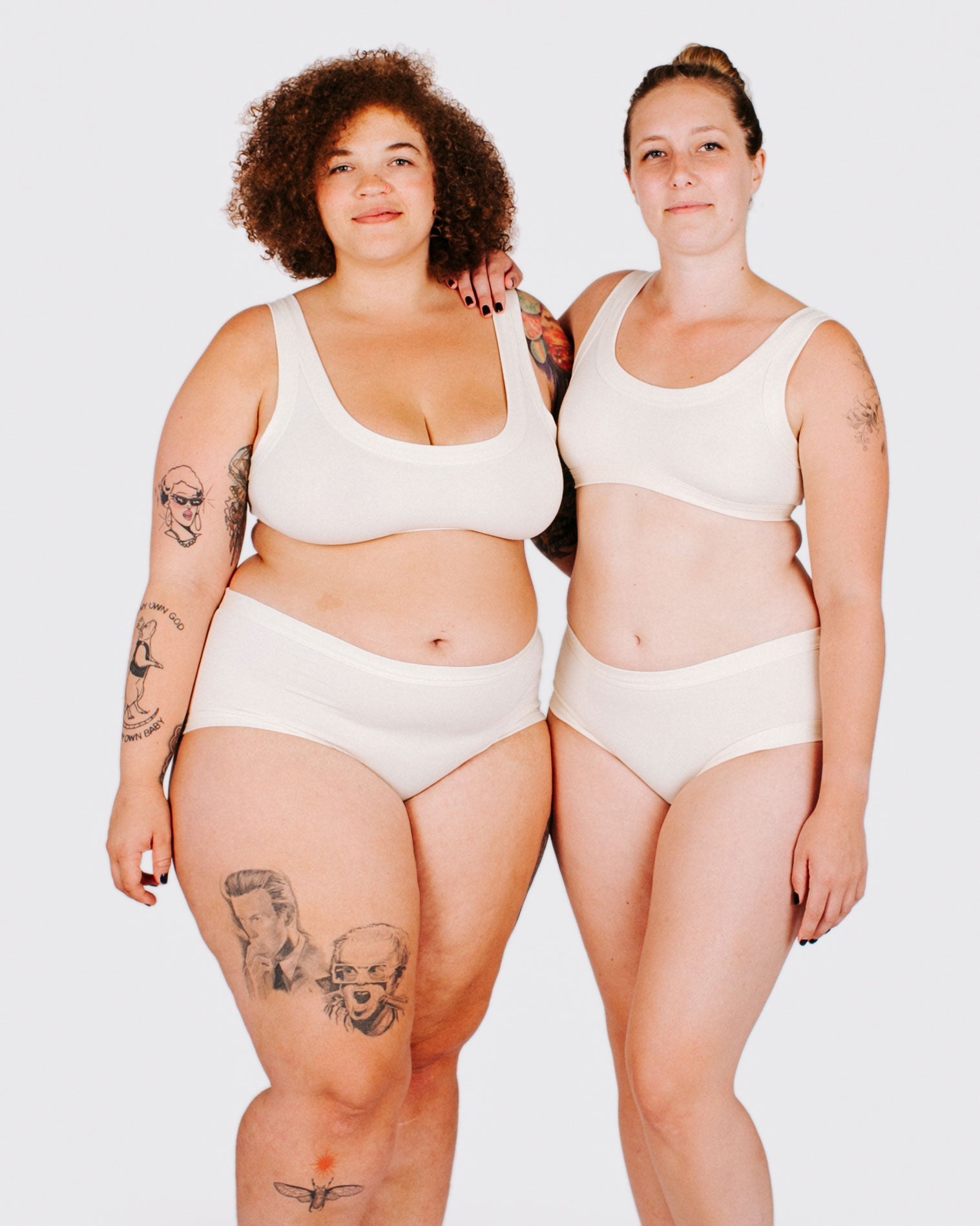 Fit photo from the front of Thunderpants organic cotton Hipster style underwear and Bralette in off-white on two models standing together.
