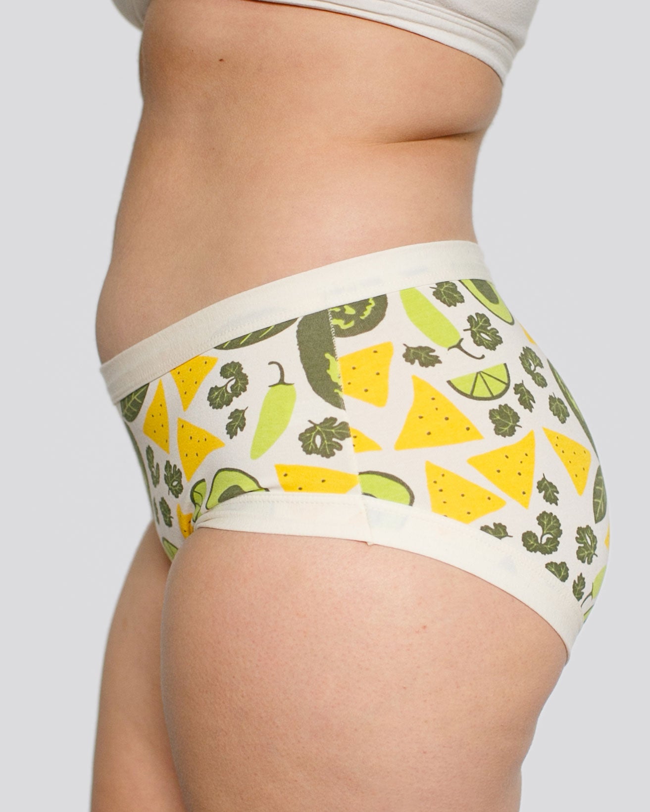 Model's side wearing Thunderpants organic cotton Hipster style underwear in our Party Guac print: deconstructed guacamole print (limes, peppers, cilantro, avocado, and chips).