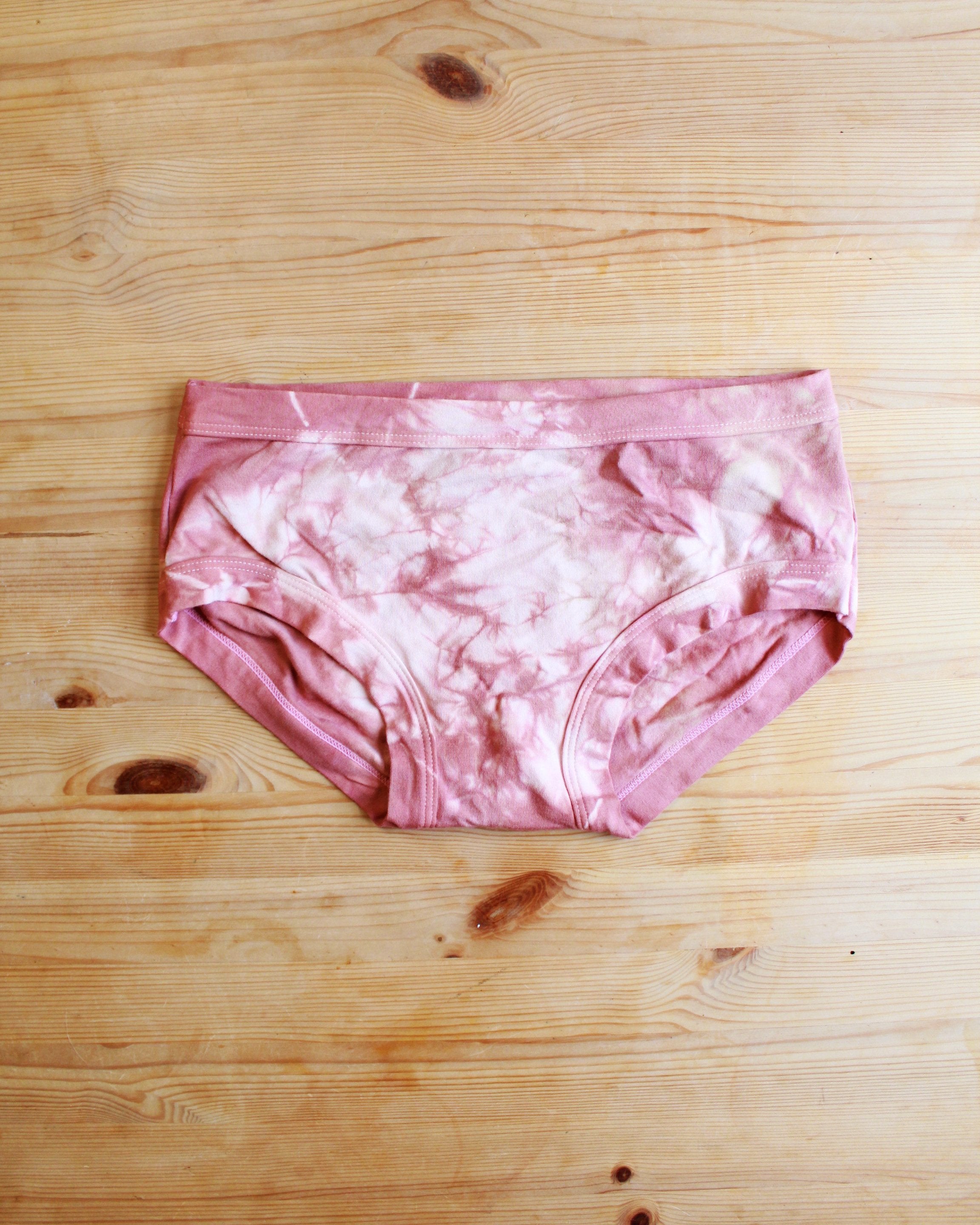 Flat lay front of Thunderpants organic cotton Women’s Hipster style underwear in limited edition hand dye pink tie dye.