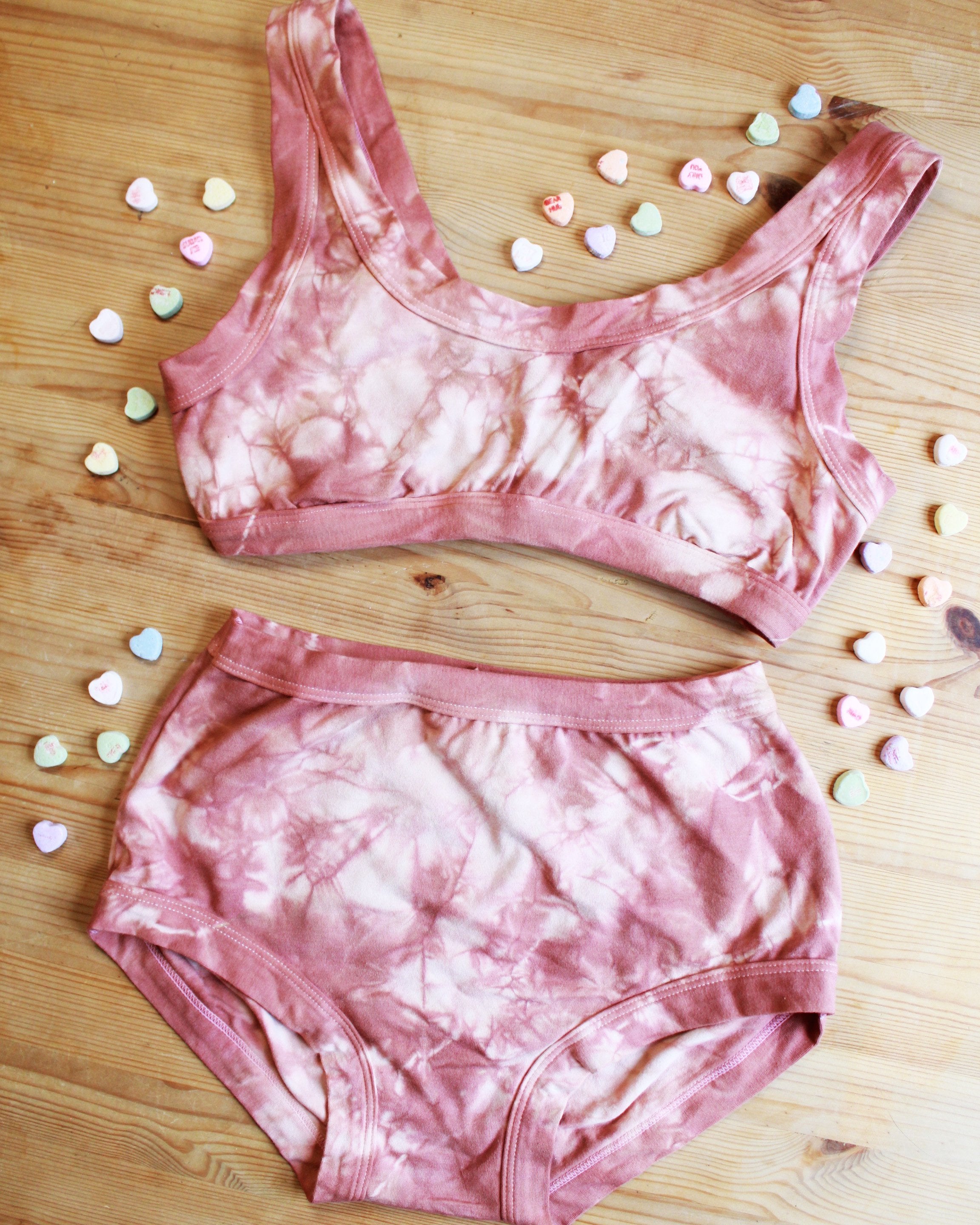 Flat-lay of Thunderpants organic cotton Bralette and Women's Original style underwear in limited edition hand dyed pink shibori tie dye.