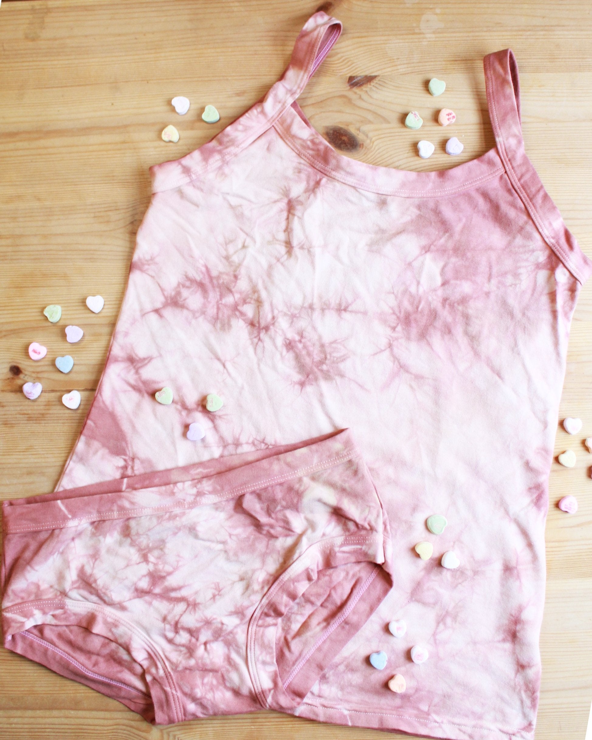 Flat lay of Thunderpants organic cotton Women’s Hipster style underwear and Camisole in limited edition hand dye pink tie dye.