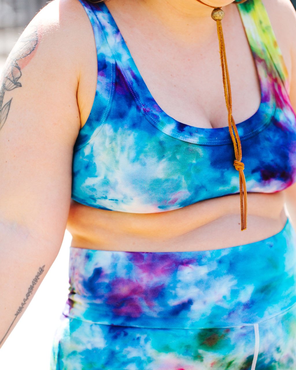 Close up of model wearing Thunderpants organic cotton Bralette in hand dyed Ice Dye multicolored tie-dye.