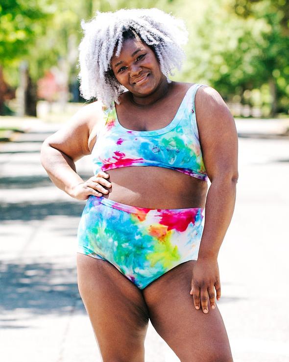 Close up of model wearing Thunderpants organic cotton Original style underwear and Bralette in our hand dye Ice Dye multicolored tie-dye.