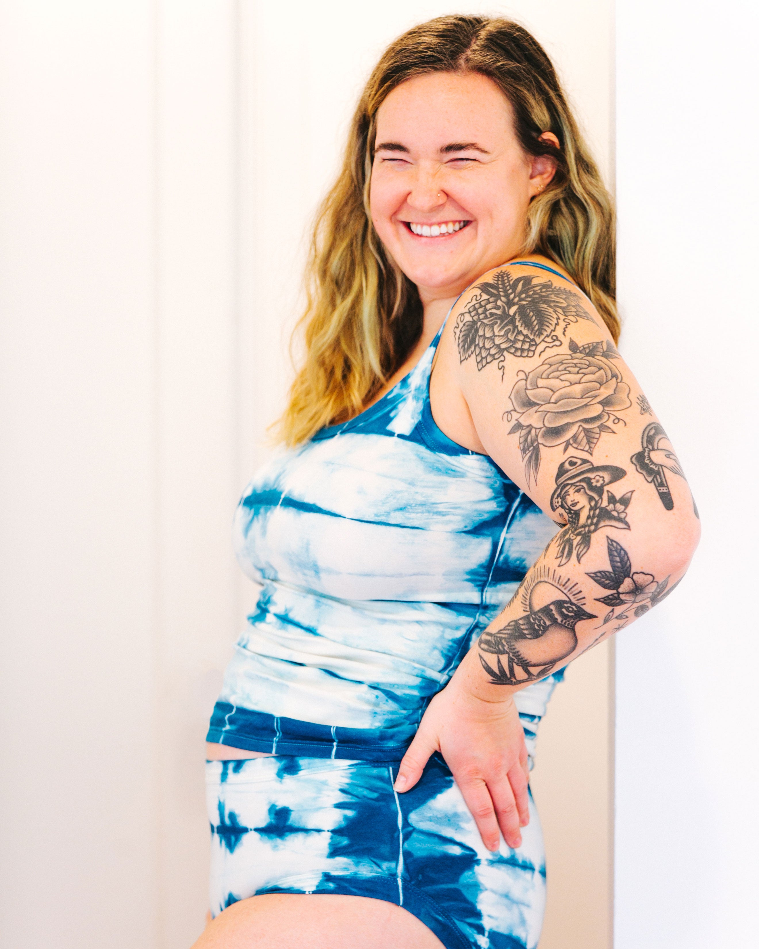 Photo from the side of Thunderpants Organic Cotton Camisole and Hipster style underwear in shibori hand dyed Indigo color on a smiling model.