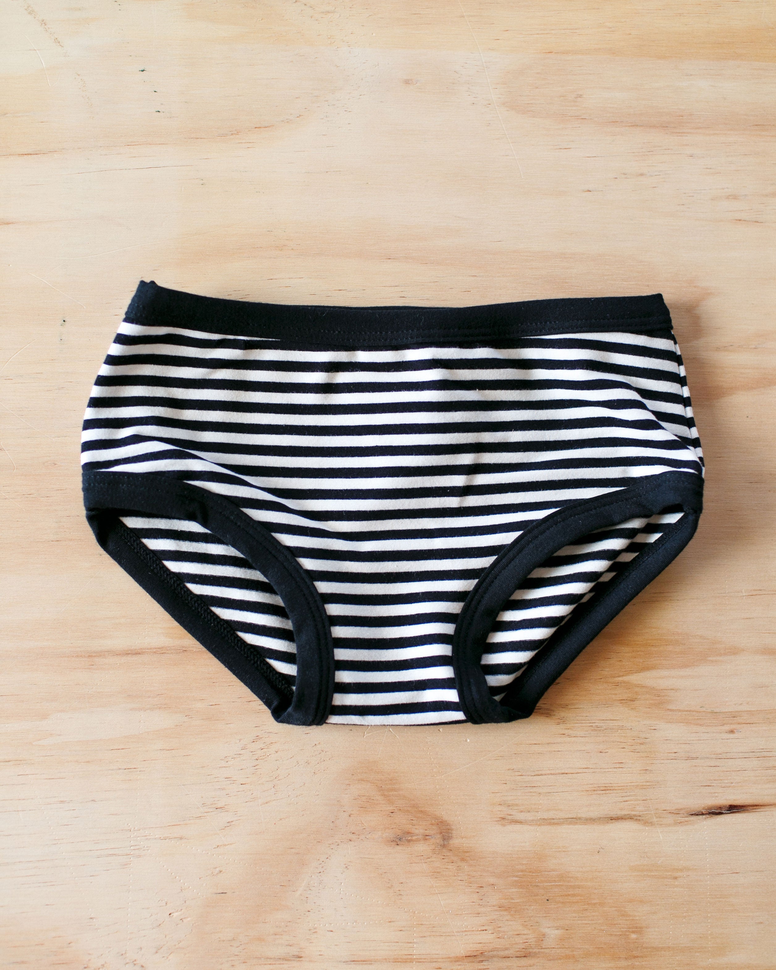 Flat lay of Thunderpants organic cotton Kids style in Black and White Stripes.