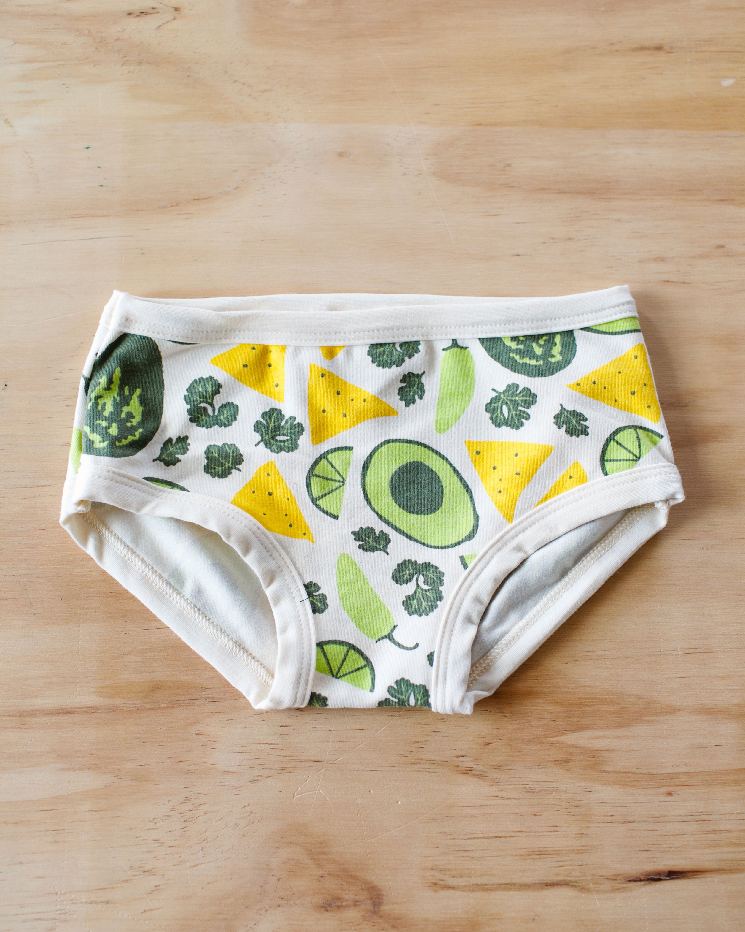 Flat lay of Thunderpants Kids style underwear in our Party Guac print: a deconstructed guacamole (avocado, cilantro, pepper, lime, and tortilla chip) print.