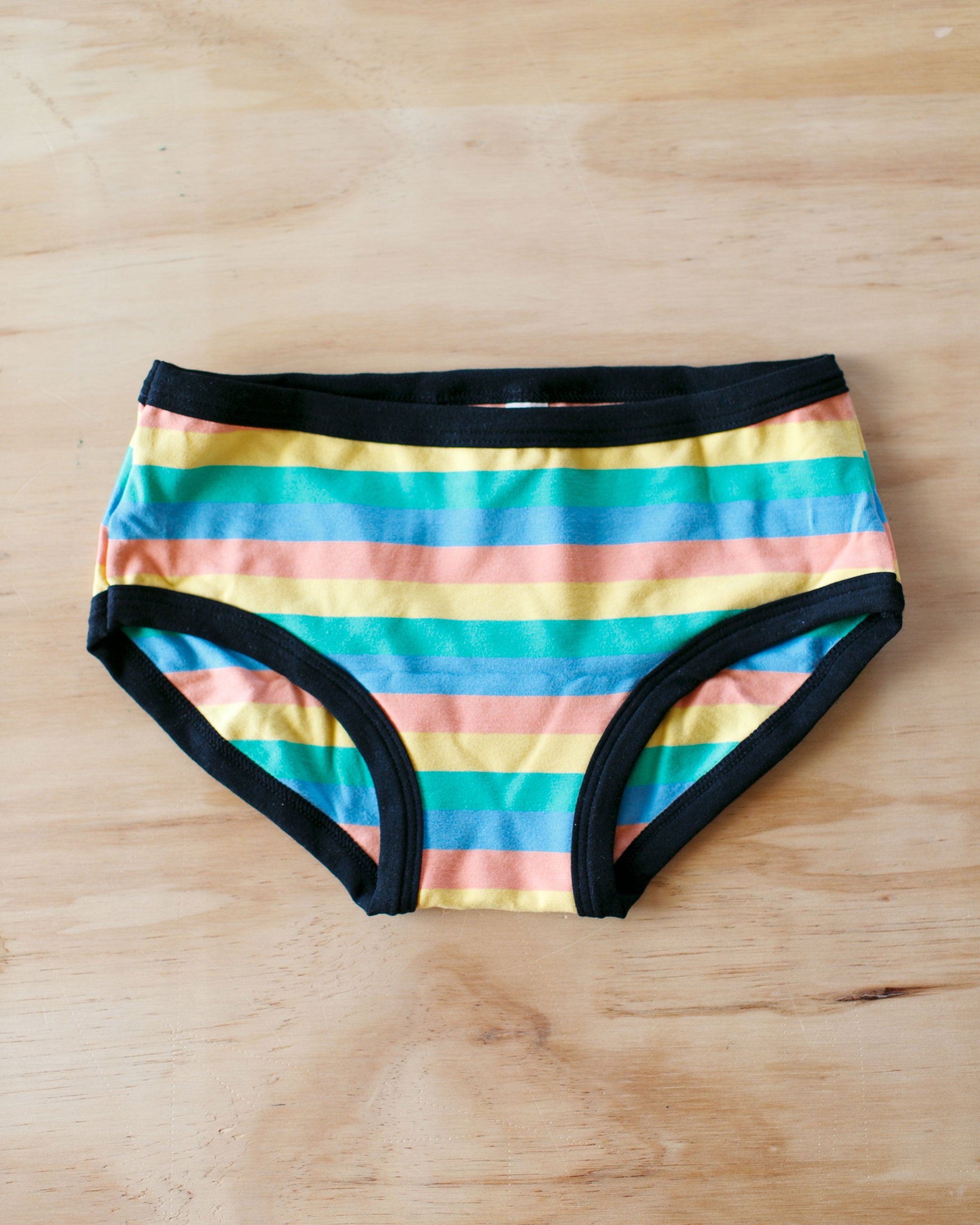 Flat lay of Thunderpants Kids style underwear in Pastel Rainbow Stripes.