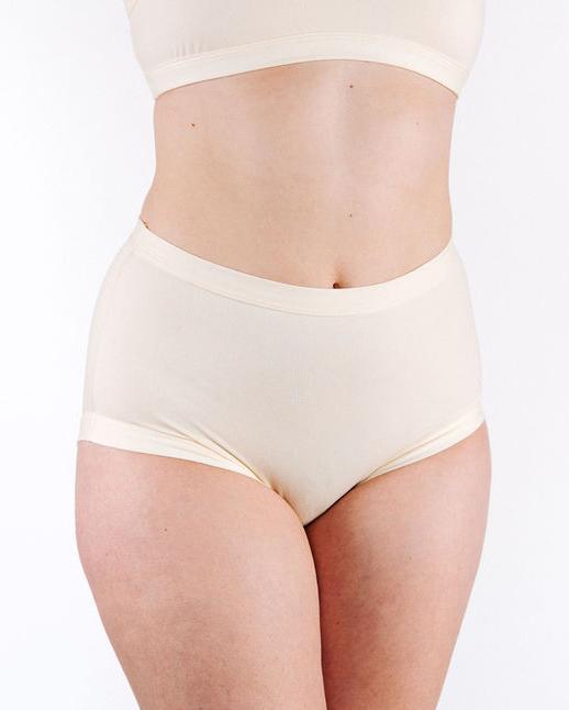 Fit photo from the front of Thunderpants organic cotton Women’s Original style underwear in off-white on a woman.