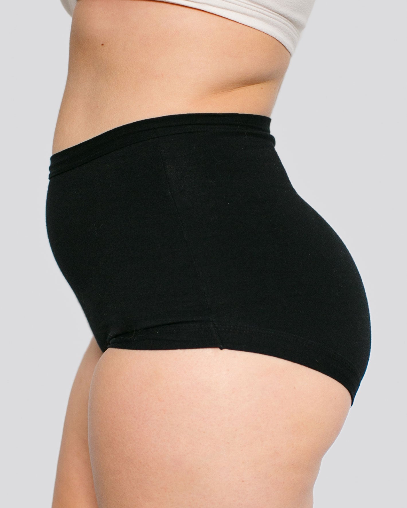 Fit photo from the side of Thunderpants organic cotton Sky Rise style underwear in Plain Black on a model.