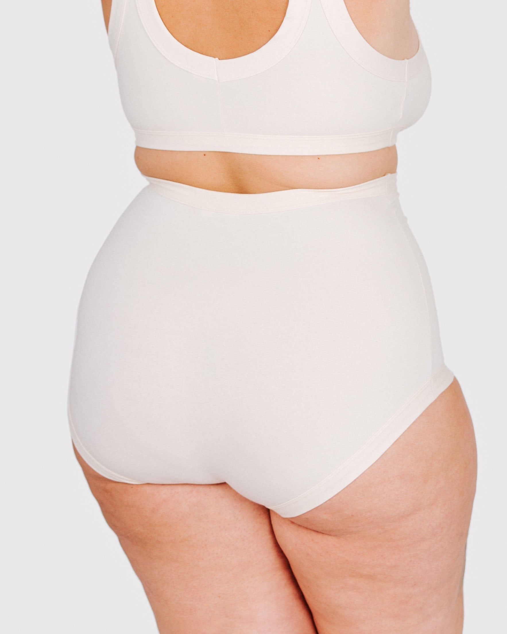 Fit photo from the back of Thunderpants organic cotton Sky Rise style underwear in off-white on, showing a wedgie-free bum, on a model.