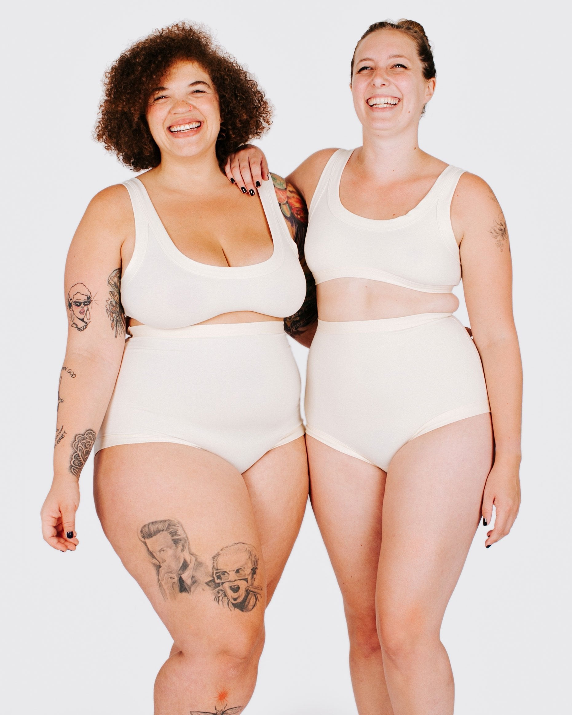 Fit photo from the front of Thunderpants organic cotton Sky Rise style underwear and Bralette in off-white on two model standing together.