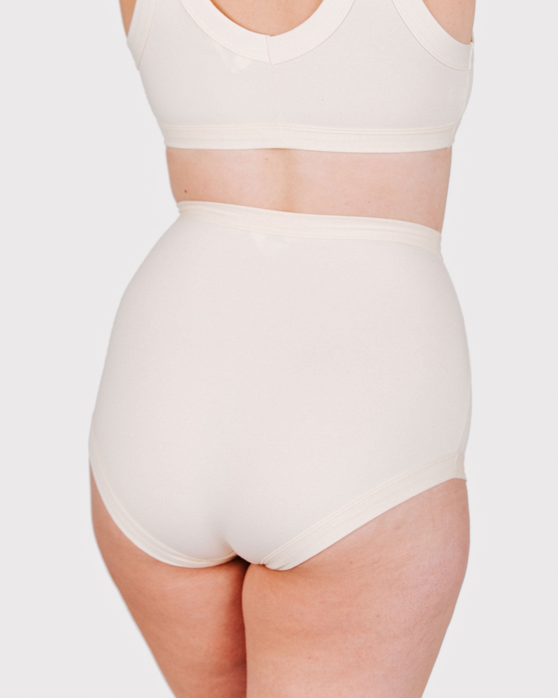 Fit photo from the back of Thunderpants organic cotton Sky Rise style underwear in off-white on, showing a wedgie-free bum, on a model.