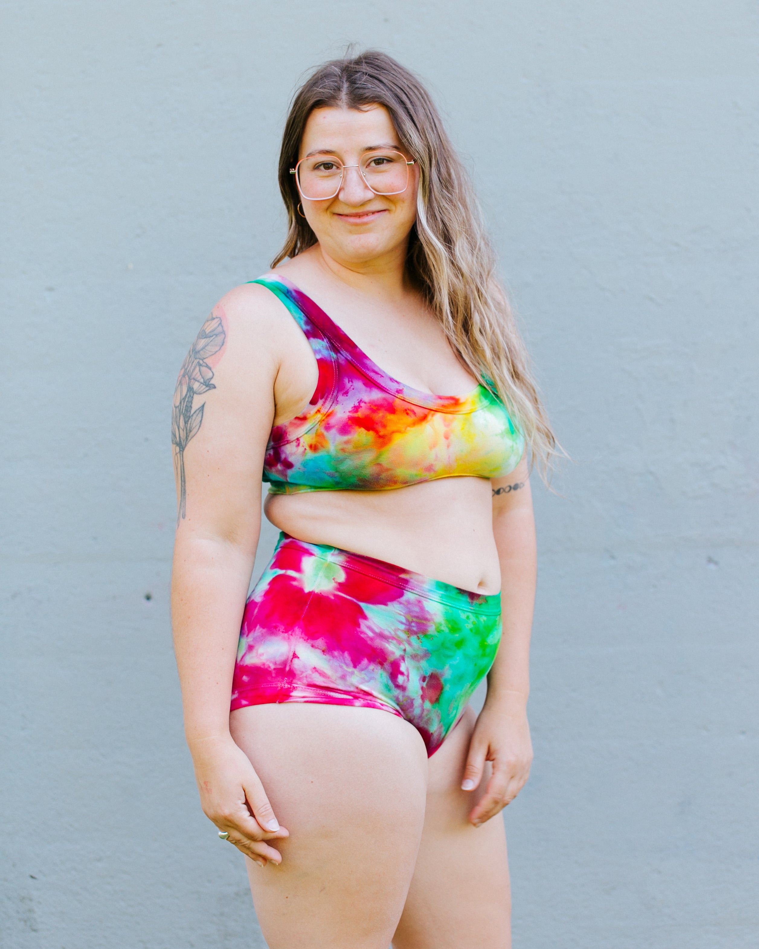 Model wearing Ice Dyed set of Original style underwear and Bralette in a mix of pink, green, and yellow colors.