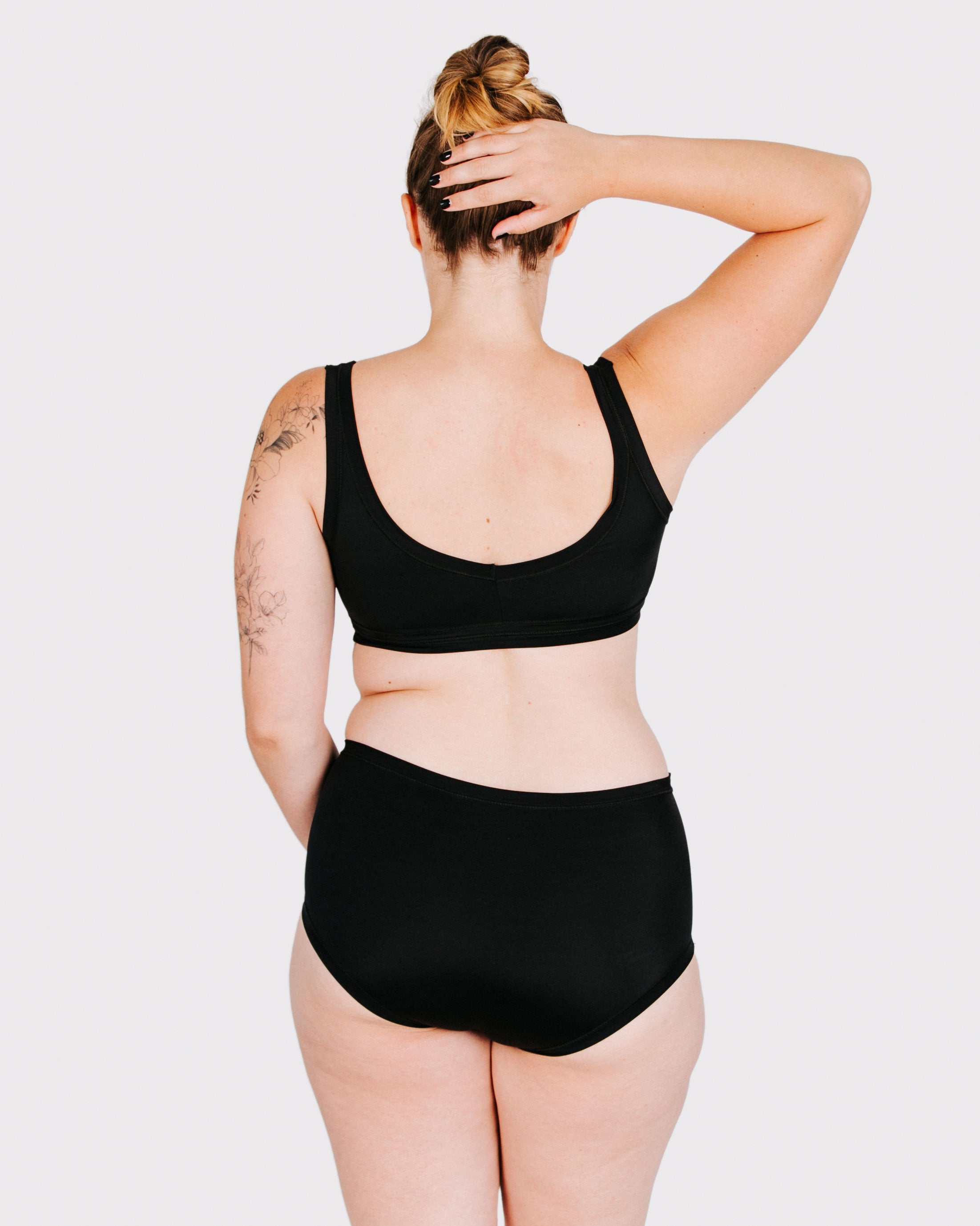 Fit photo from the back of Thunderpants recycled nylon Swimwear Original style bottoms in Plain Black, showing a wedgie-free bum, on a model.