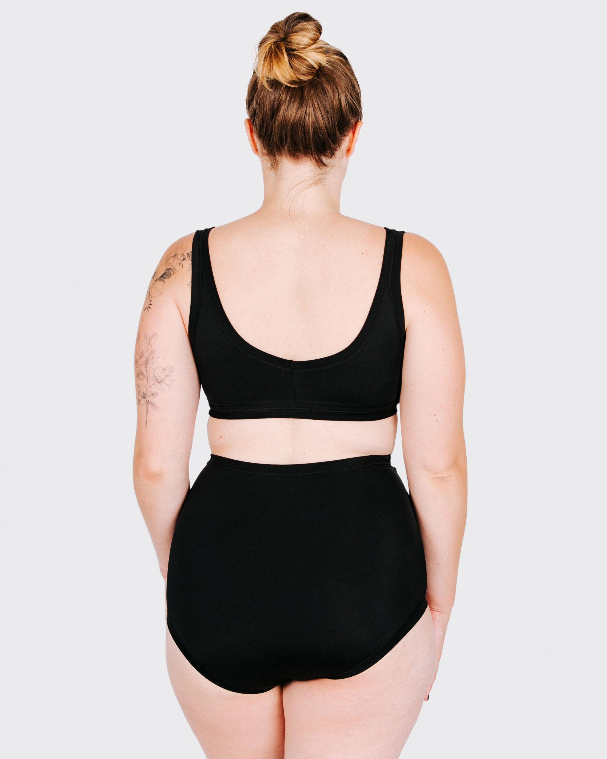 Fit photo from the back of Thunderpants recycled nylon Swimwear Sky Rise style bottoms in Plain Black, showing a wedgie-free bum, on a model.