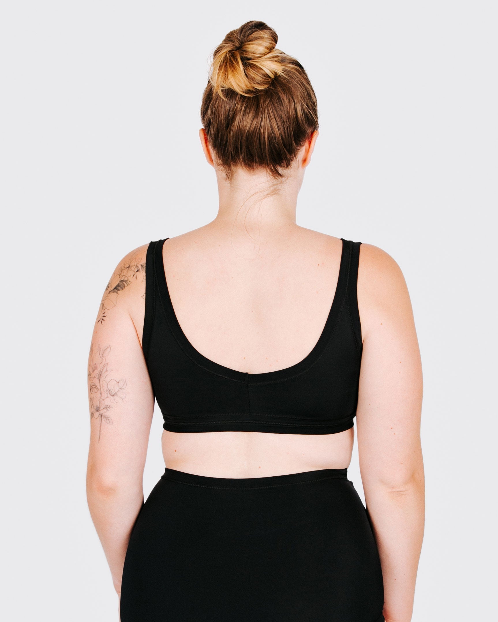 Fit photo from the back of Thunderpants recycled nylon Swimwear Top in Plain Black on a model.
