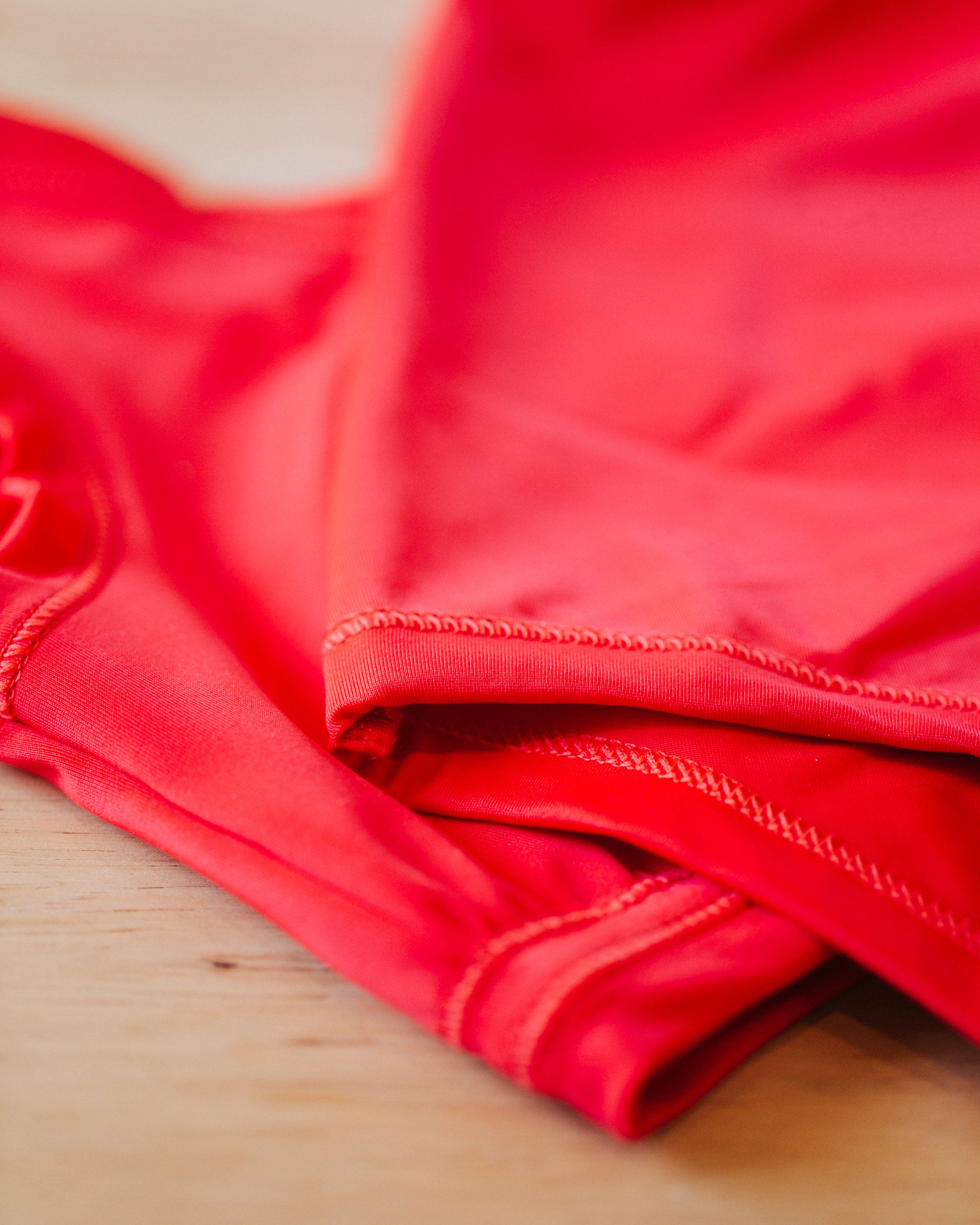 Close up of the Classic Red swimwear, showing the stitching and details.