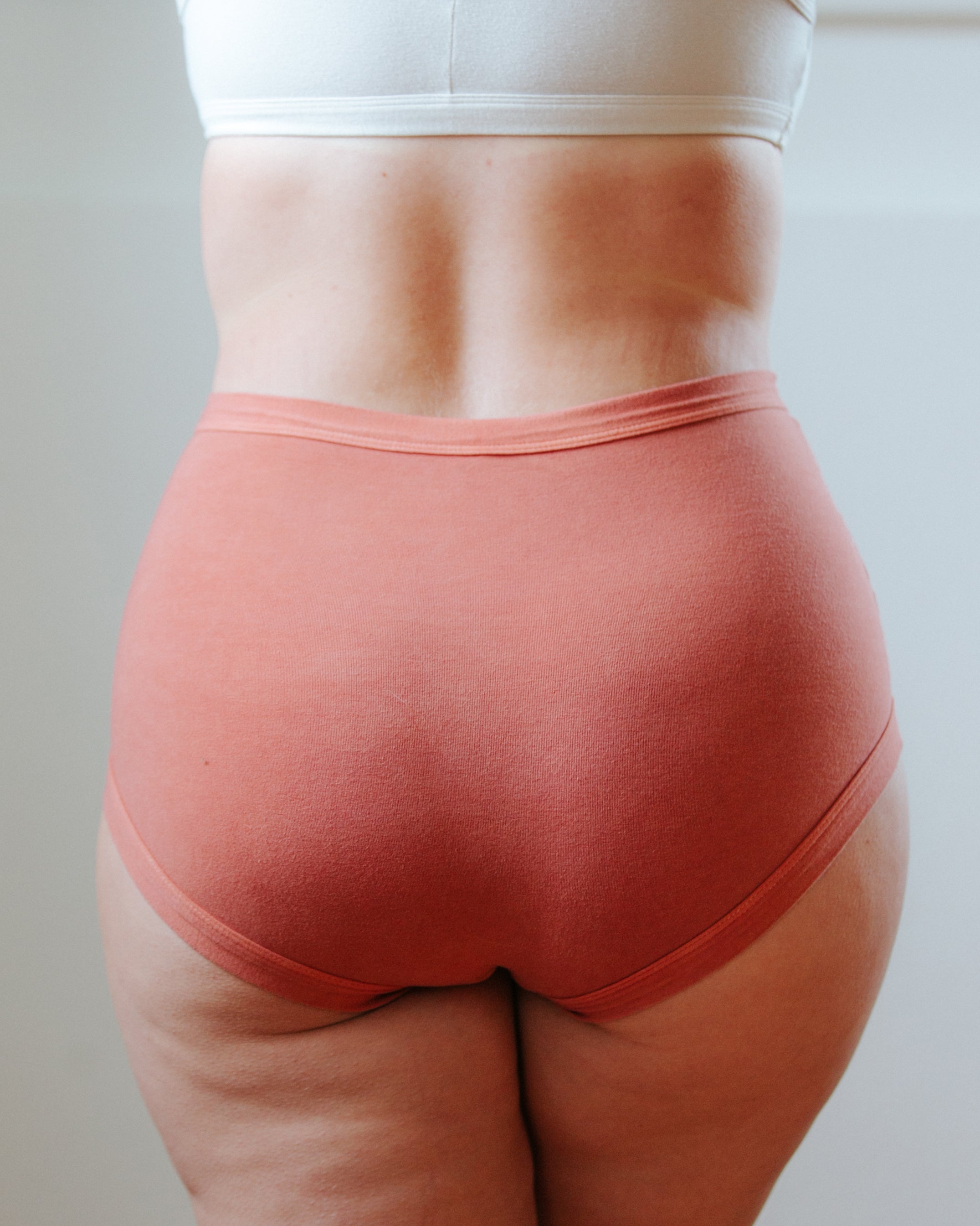 Photo of a bum showing Thunderpants Organic Cotton original style underwear in hand dyed Terracotta color on a model.