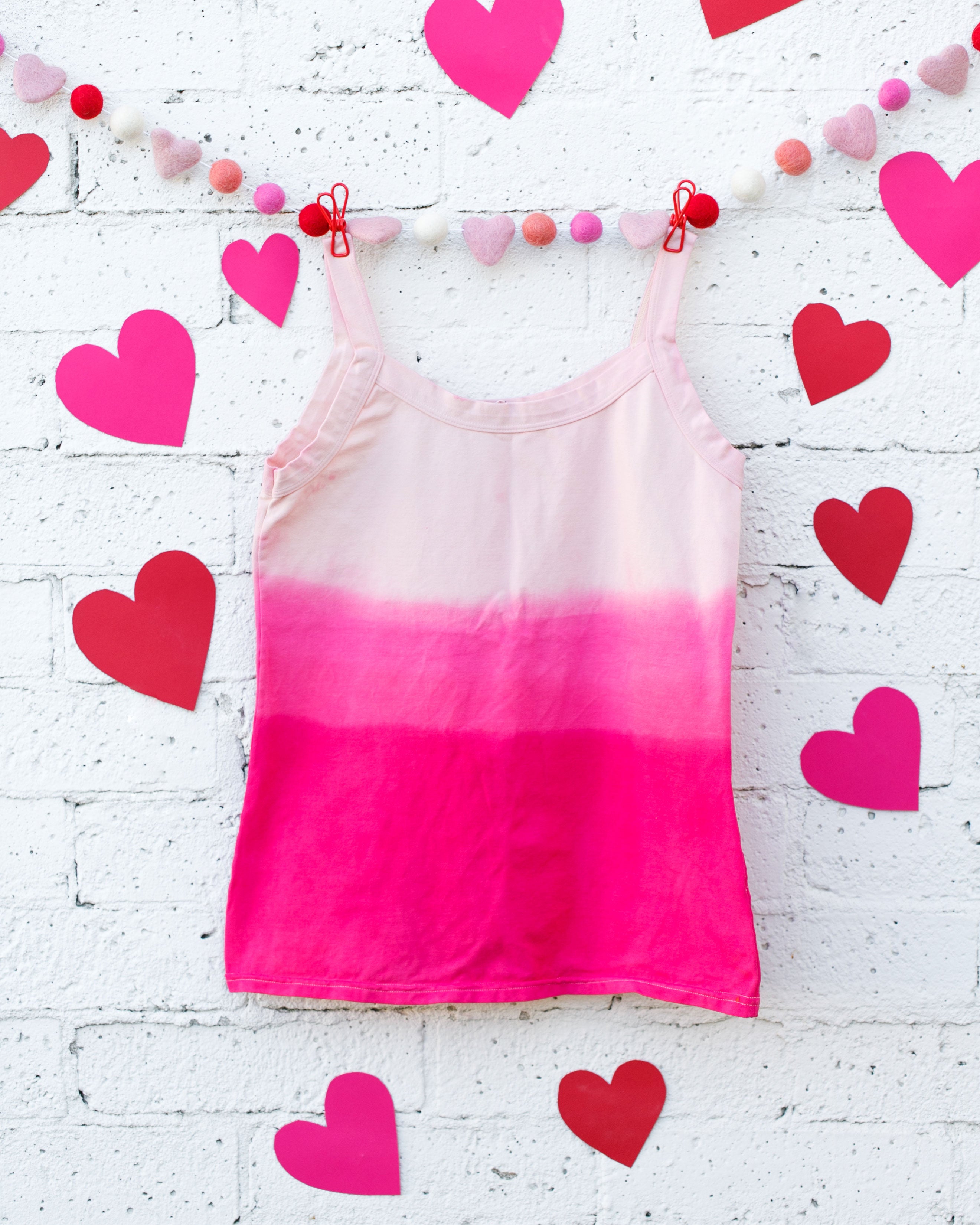 Photo of Thunderpants organic cotton Camisole in Valentine's Day Dip Dye ombre pinks with hearts around.