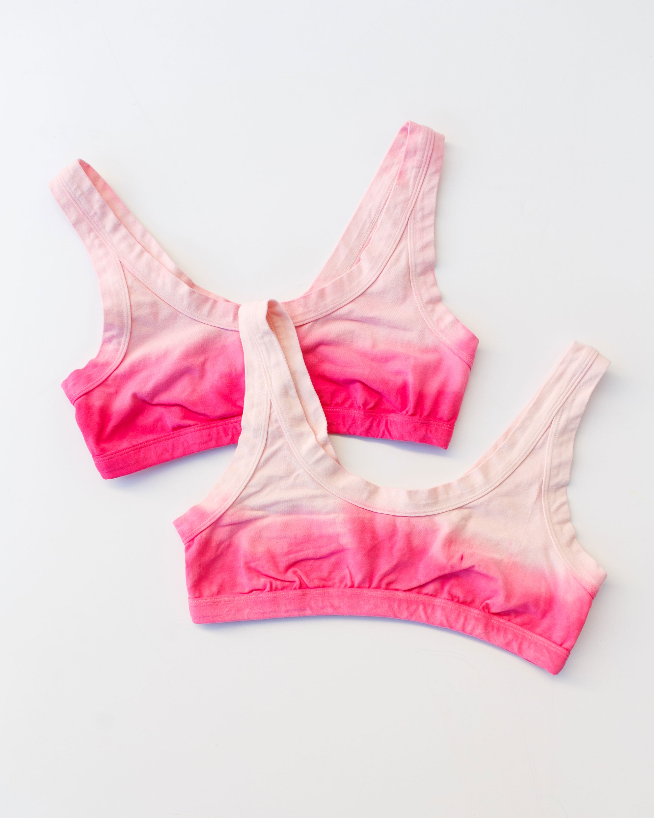 Flat lay of Thunderpants Organic Cotton Bralette in Valentine's Day Dip Dye ombre pinks.