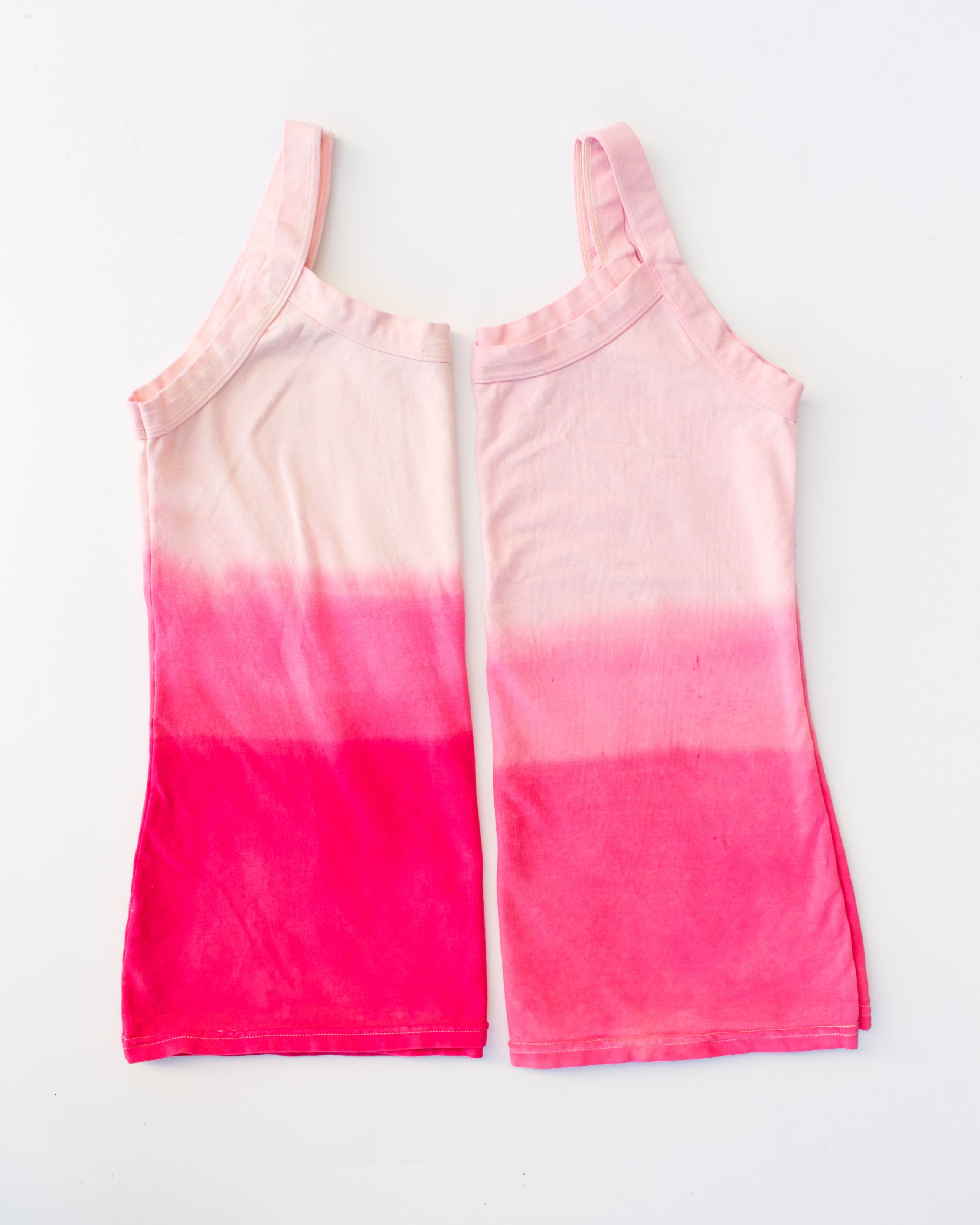 Flat lay of Thunderpants organic cotton Camisoles in Valentine's Day Dip Dye ombre pinks.
