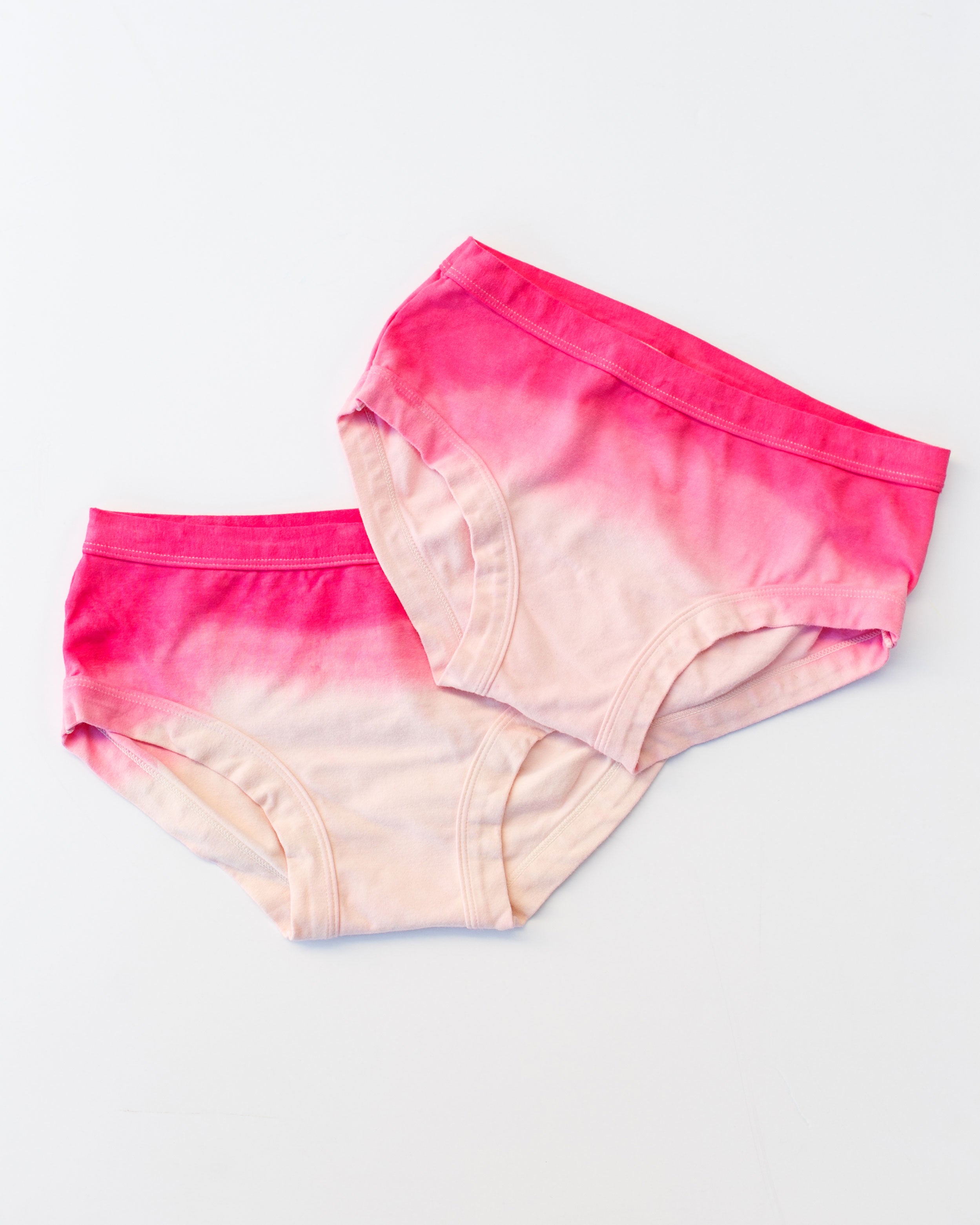 Flat lay of Thunderpants organic cotton Hipster underwear in Valentine's Day Dip Dye ombre pinks.