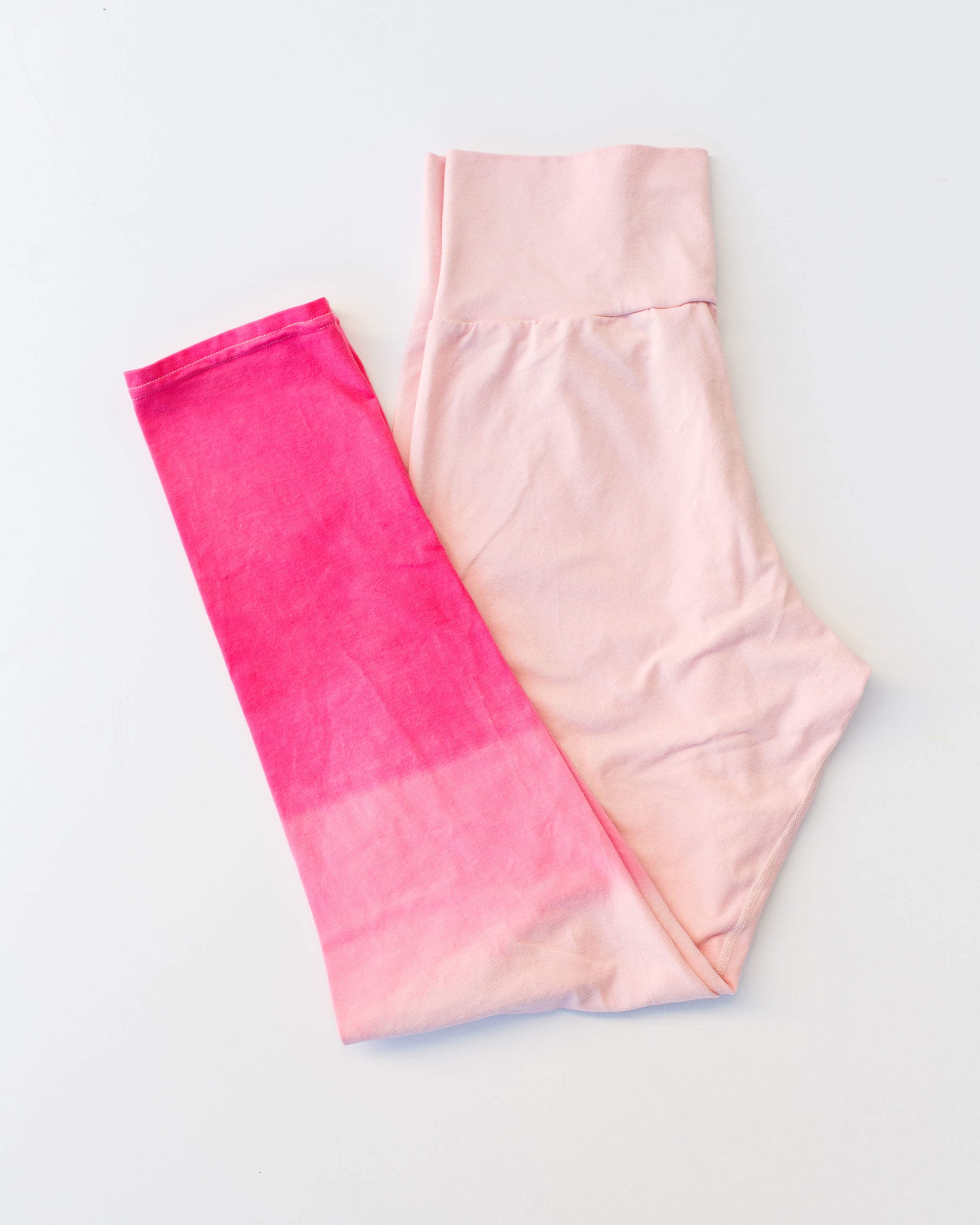 Flat lay of Thunderpants organic cotton Leggings in Valentine's Day Dip Dye ombre pinks.