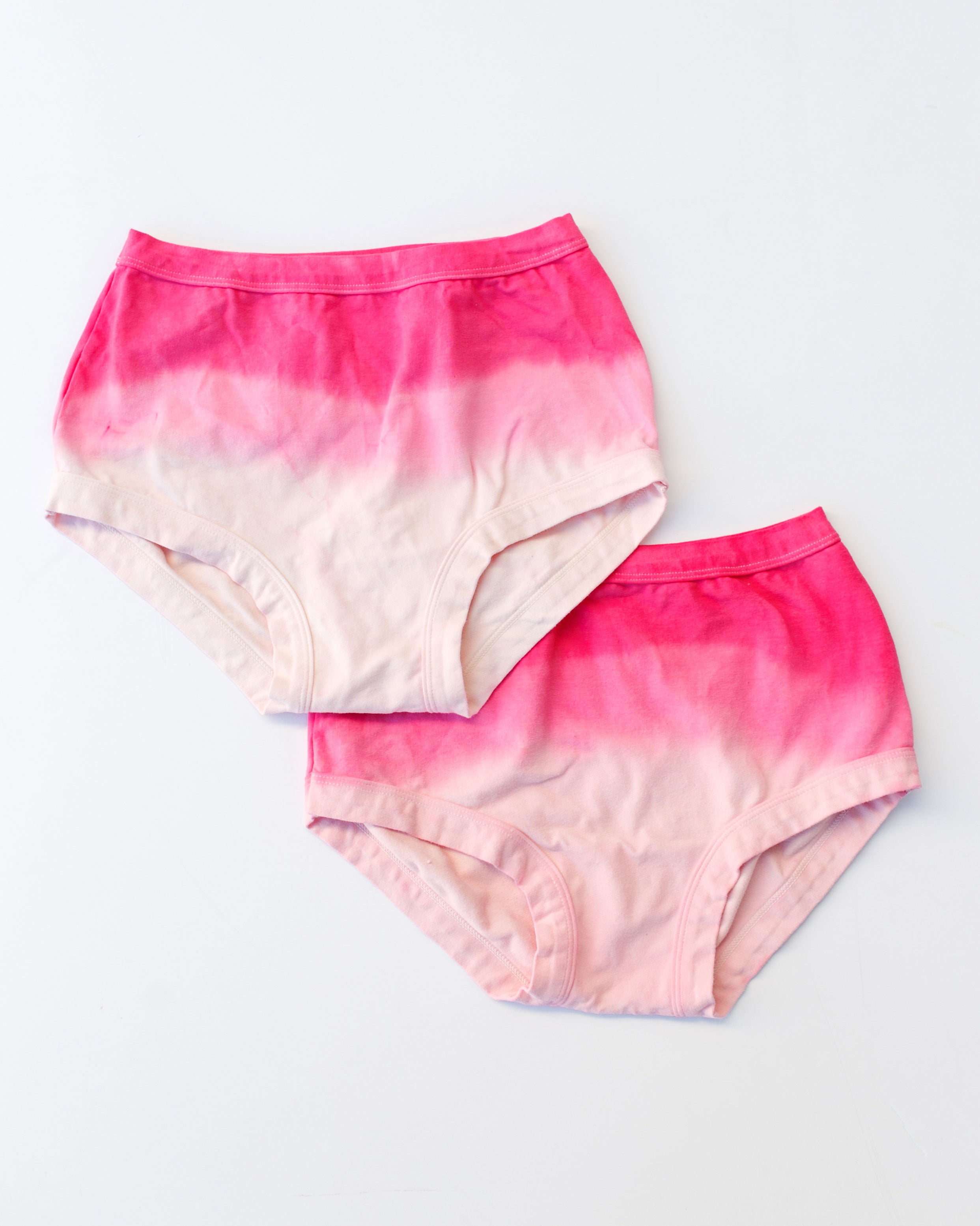 Flat lay of Thunderpants organic cotton Original underwear in Valentine's Day Dip Dye ombre pinks.