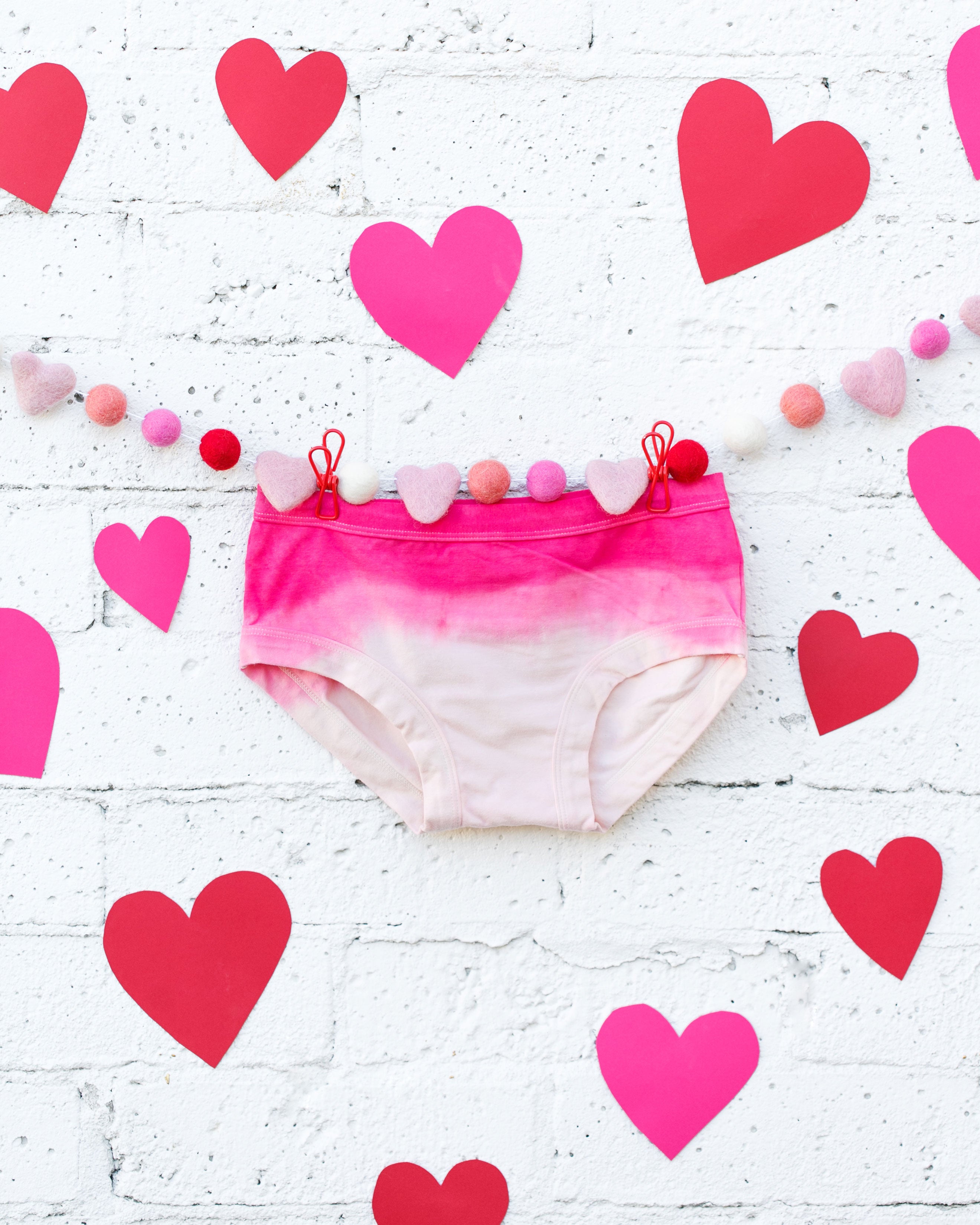 Photo of Thunderpants organic cotton hipster underwear in Valentine's Day Dip Dye ombre pinks with hearts around.
