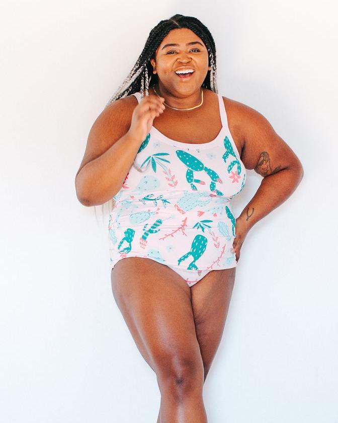Beautiful happy plus-sized model wearing Thunderpants organic cotton Camisole and Original style underwear in a pink and green cactus print in front of a whiter background.