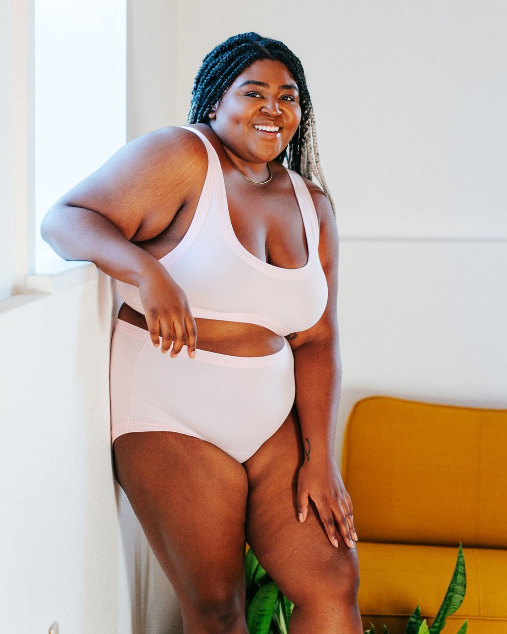 Smiling plus-sized model wearing Thunderpants organic cotton Original style underwear and Bralette in plain Perfect Pink color.